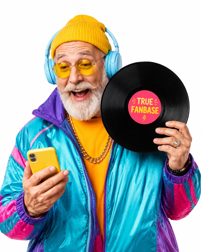 A fan in colorful streetwear holding a phone and a True Fanbase vinyl record